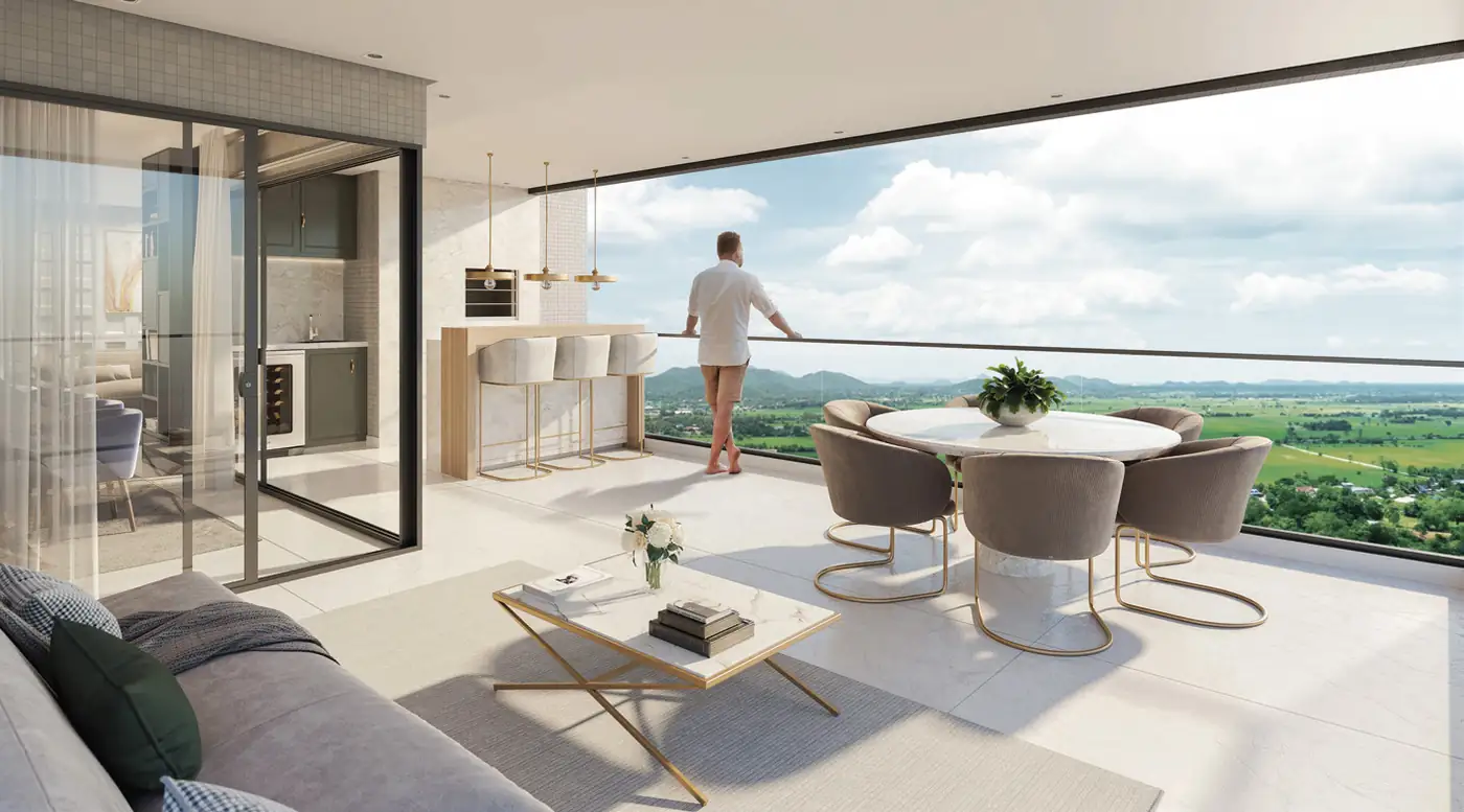 Living room opening onto a wide deck overlooking green hills, representational image
